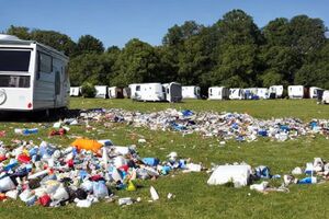A field overrun by Travellers who have left rubbish everywhere.