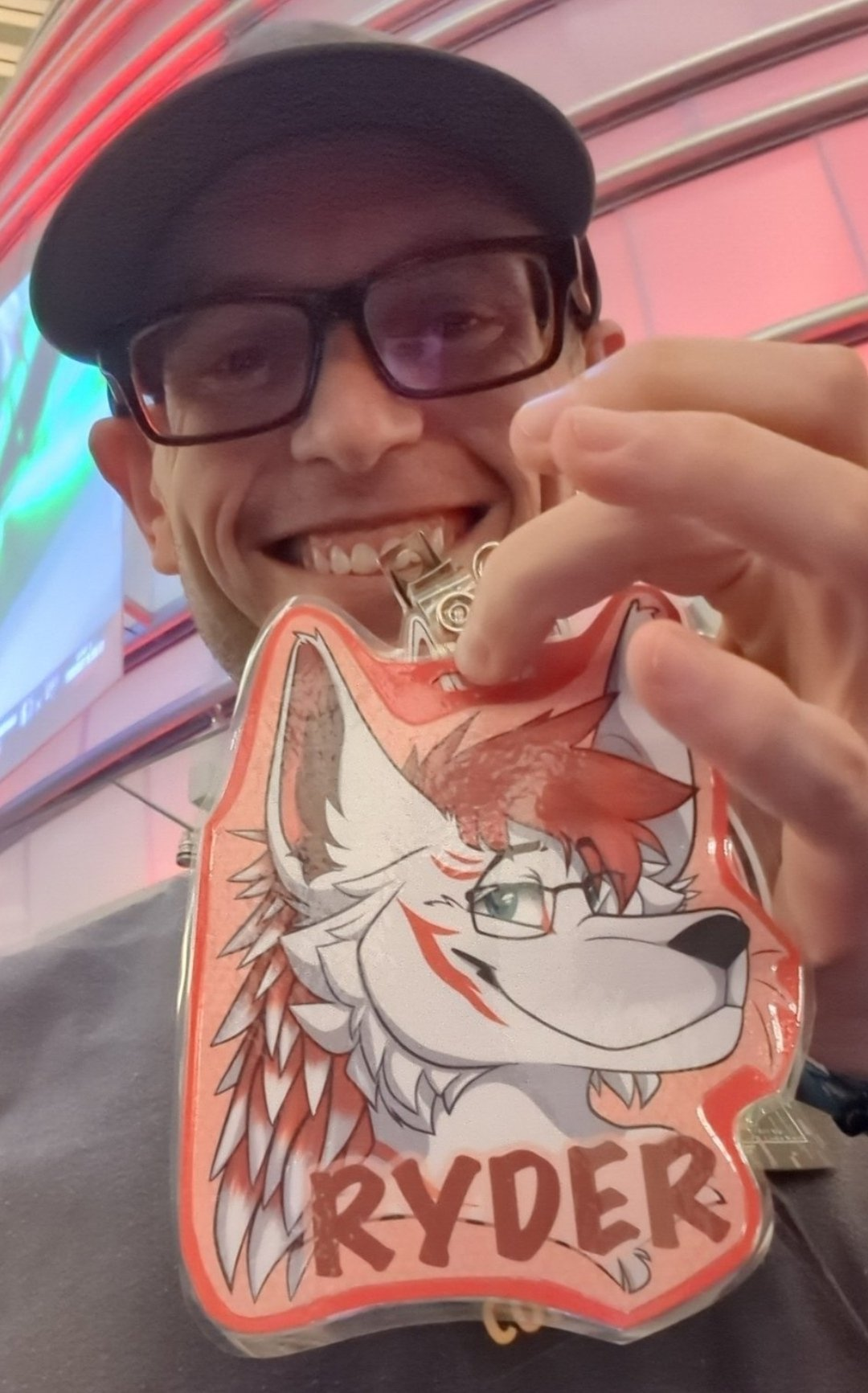 Joseph Ray Robertson holding a furry character badge bearing the name Ryder.